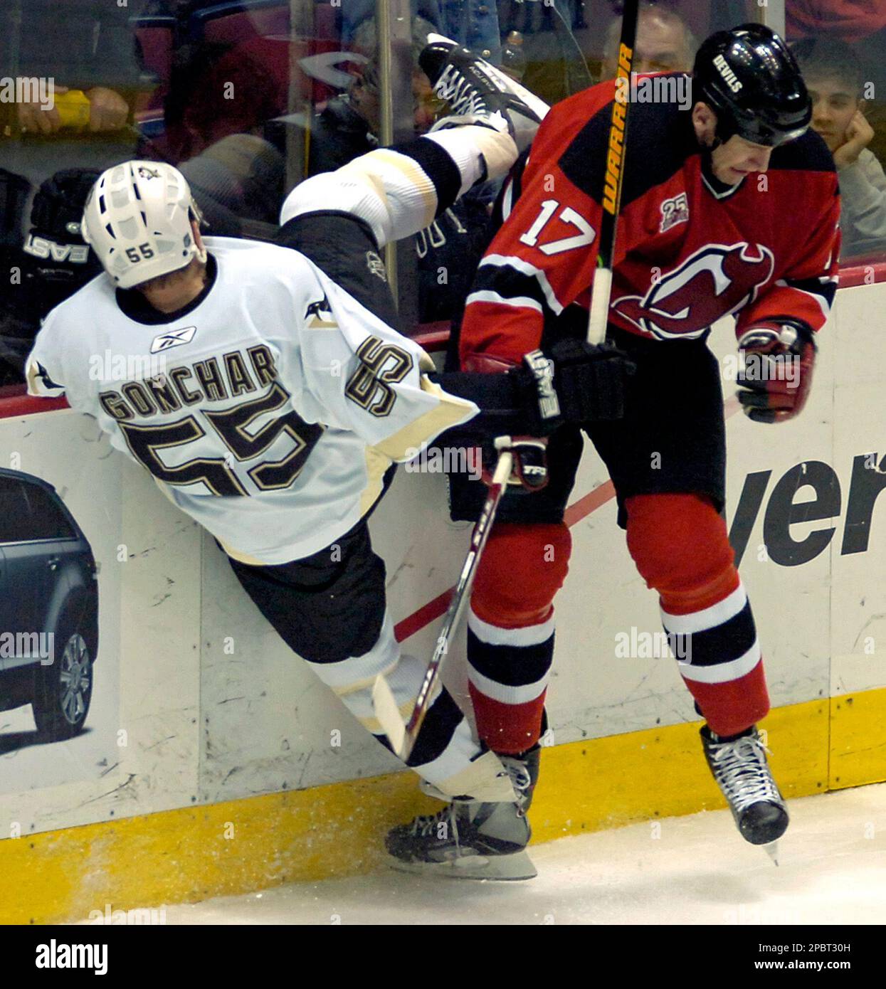 New Jersey Devils Mike Rupp right checks Pittsburgh Penguins