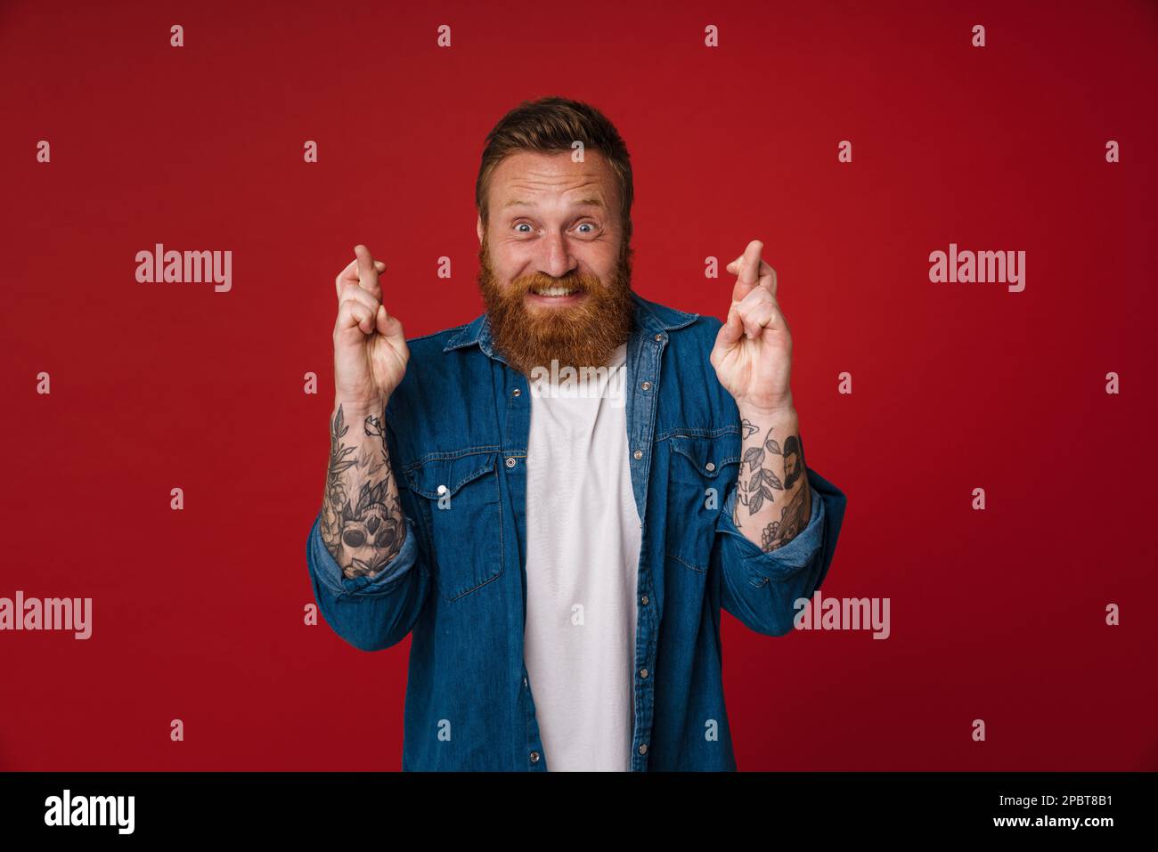 Adult bearded tattooed handsome hopeful redhead man with opened mouth ...