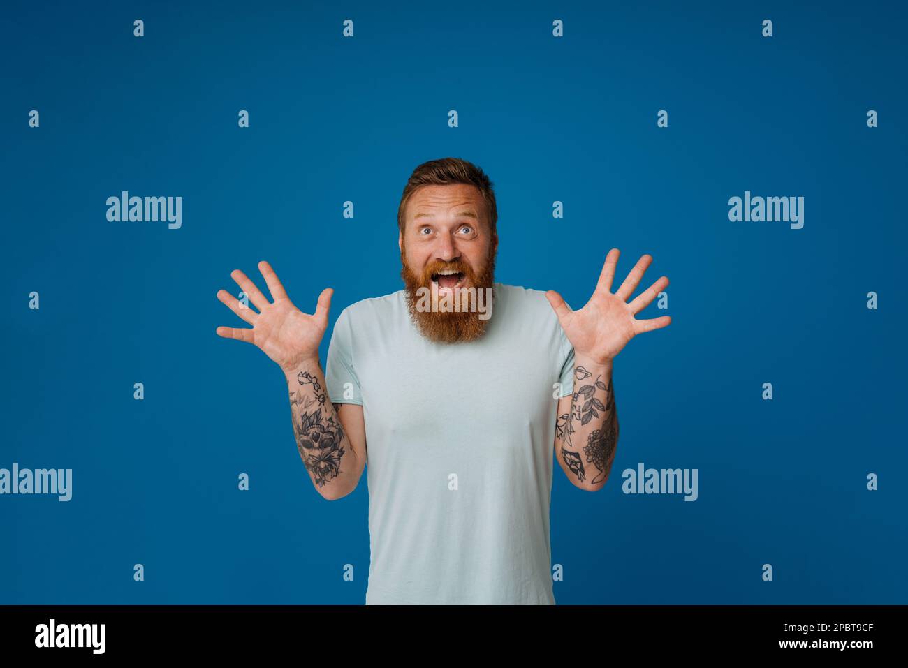 Adult bearded tattooed handsome stylish enthusiastic man with opened ...