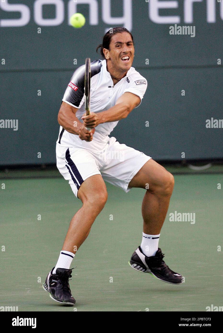 Guillermo Canas of Argentina returns the ball to defending champion and  top-seed Roger Federer of Switzerland during their second round match at  the Pacific Life Open tennis tournament in Indian Wells, Calif.