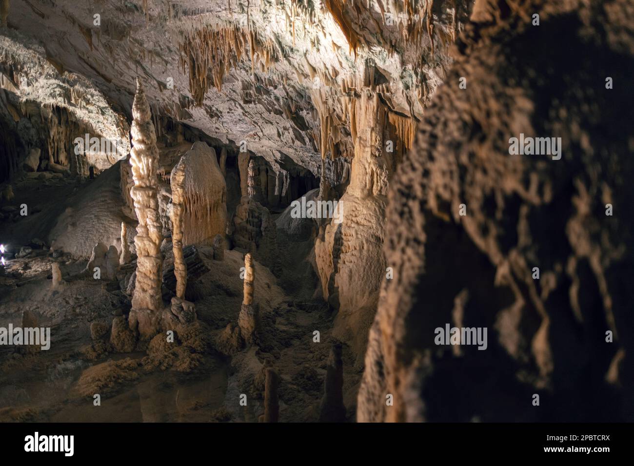 Illuminated dropstones, stalactite and stalagmite mineral formation in caves Stock Photo