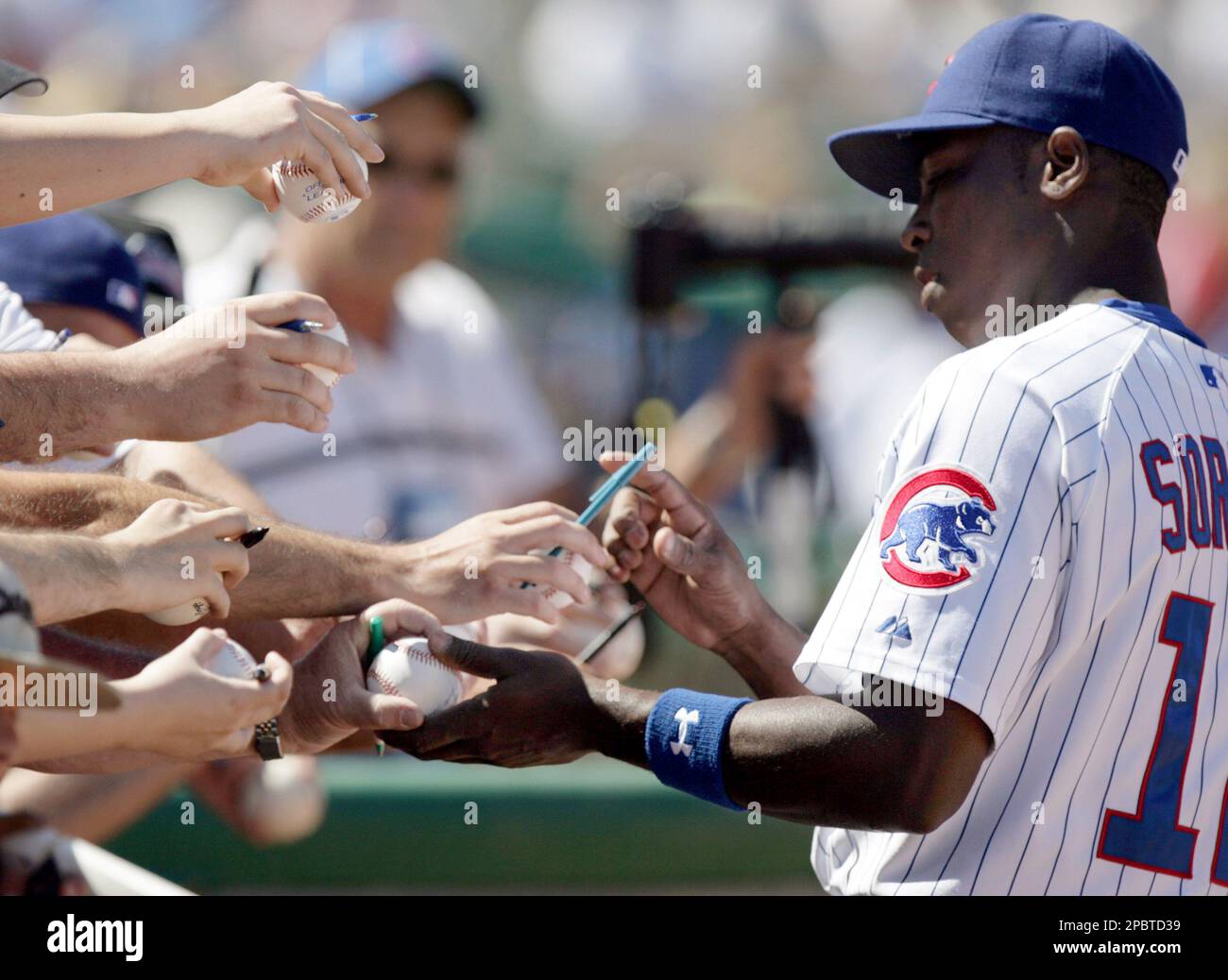 Chicago Cubs outfielder Alfonso Soriano signs autographs for fans
