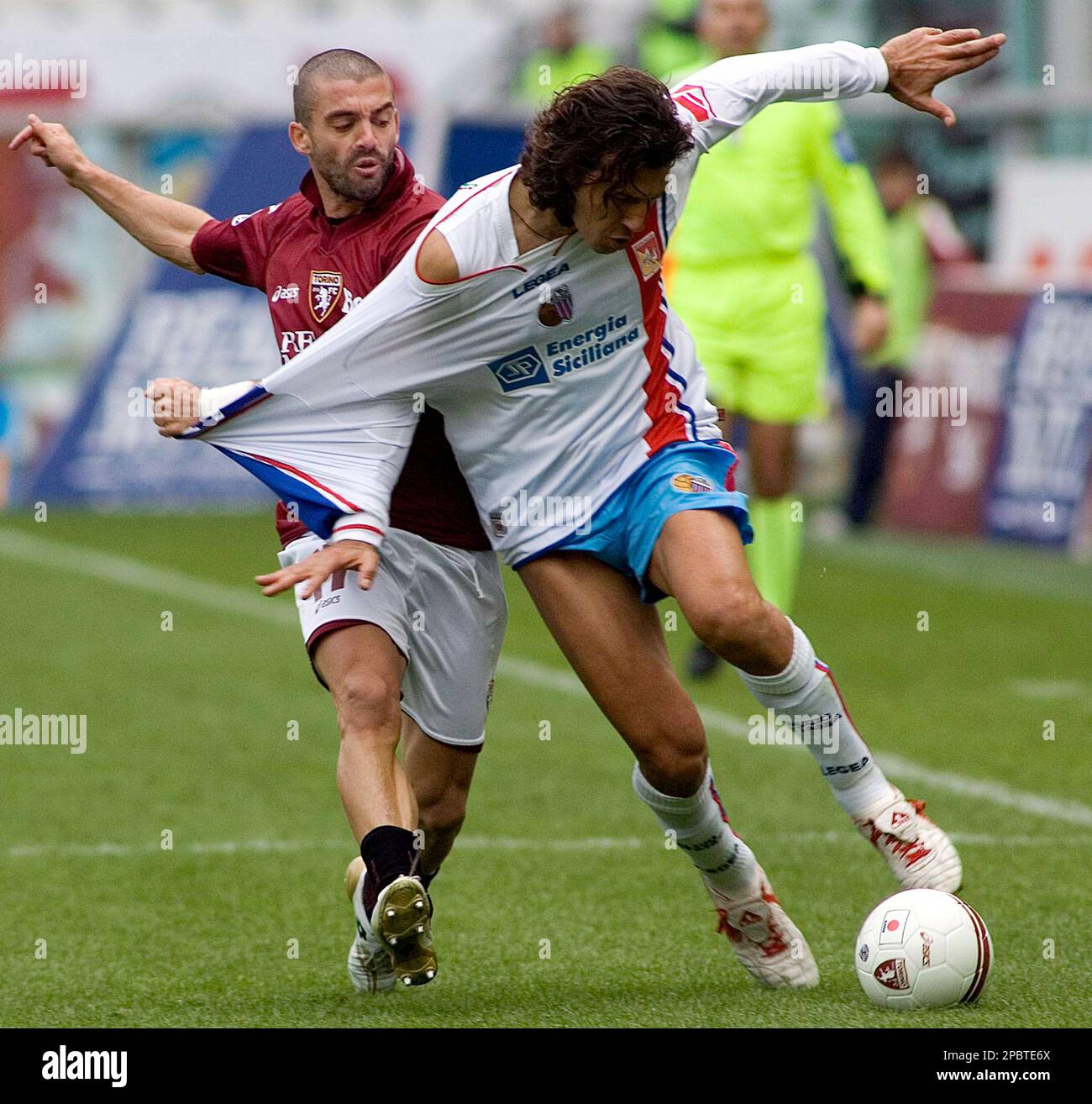Catania's Giorgio Corona, right white jersey, is pulled by Torino's Nikola  Lazetic, during the Italian Serie A first division soccer match between  Torino and Catania in Turin's stadium, northern Italy, Sunday March