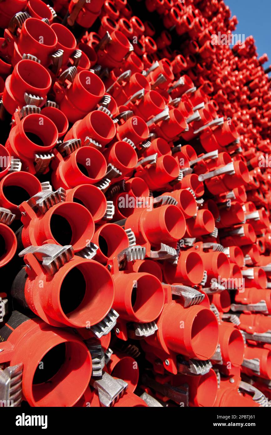 Bunches of PVC pipe sitting on palets at a wholesale pipe store Stock