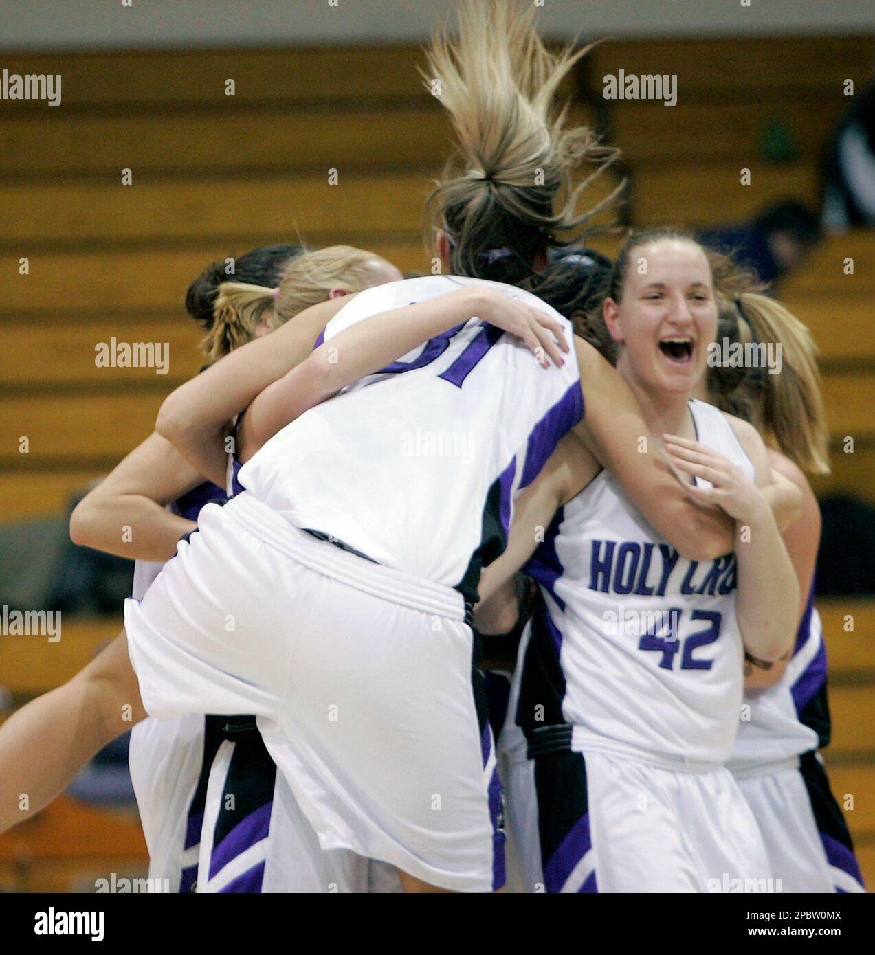 Holy Cross center Ashley Brennan-McBride leaps into the arms of her teammates and forward Kathy Gruzynski, right, at the conclusion of their Patriot League tournament championship basketball game Wednesday, March 7, 2007, in Worcester, Mass. Holy Cross defeated American 56-48 to win the women's Patriot League Championship and an automatic bid in the NCAA tournament. (AP Photo/Greg M. Cooper) Stock Photo