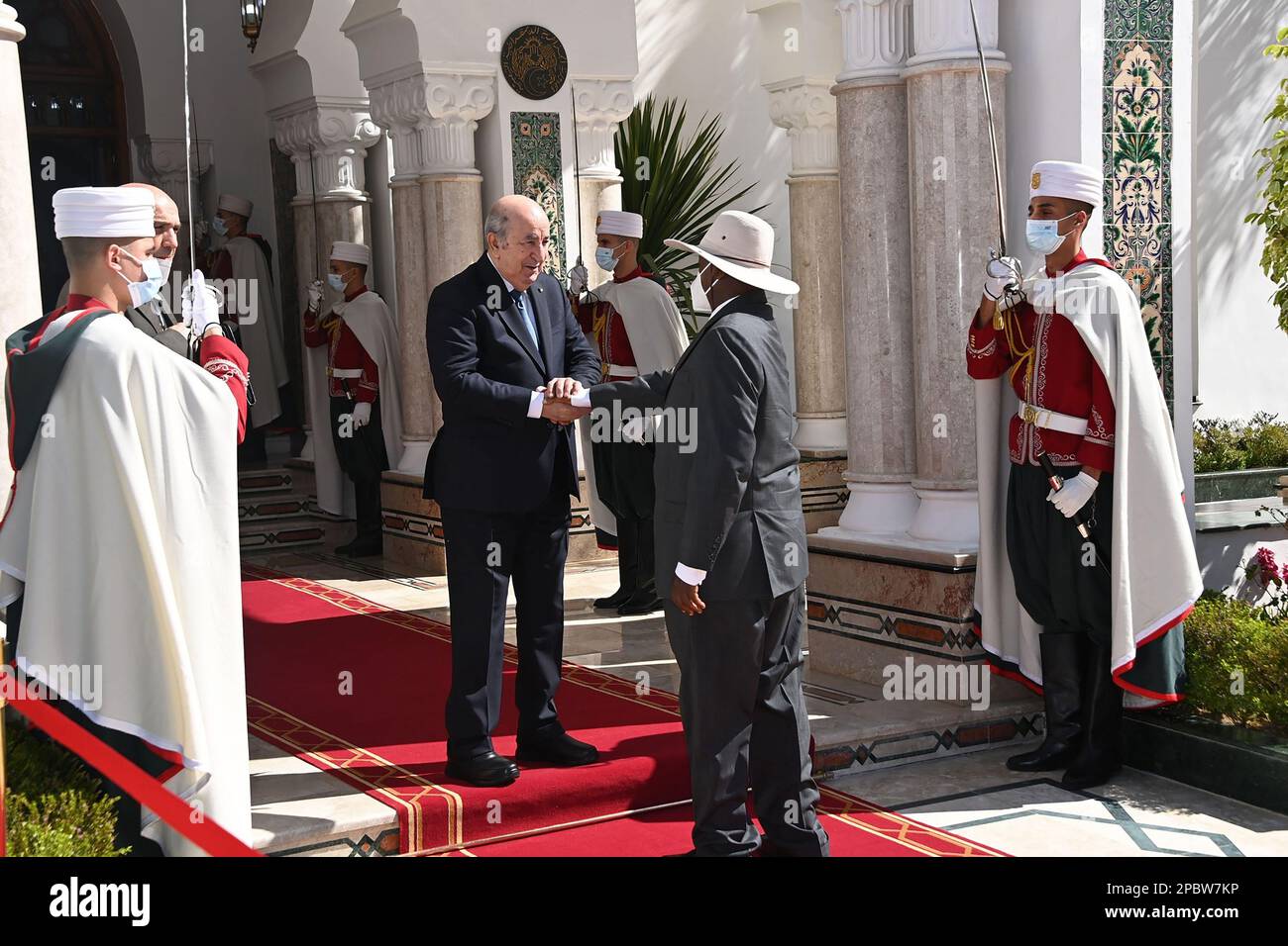 (230313) -- ALGIERS, March 13, 2023 (Xinhua) -- Algerian President Abdelmadjid Tebboune (center L) welcomes Ugandan President Yoweri Museveni (center R) in Algiers, Algeria, on March 12, 2023. TO GO WITH 'Algeria, Uganda sign pacts to boost economic cooperation' (Algerian Presidency/Handout via Xinhua) Stock Photo