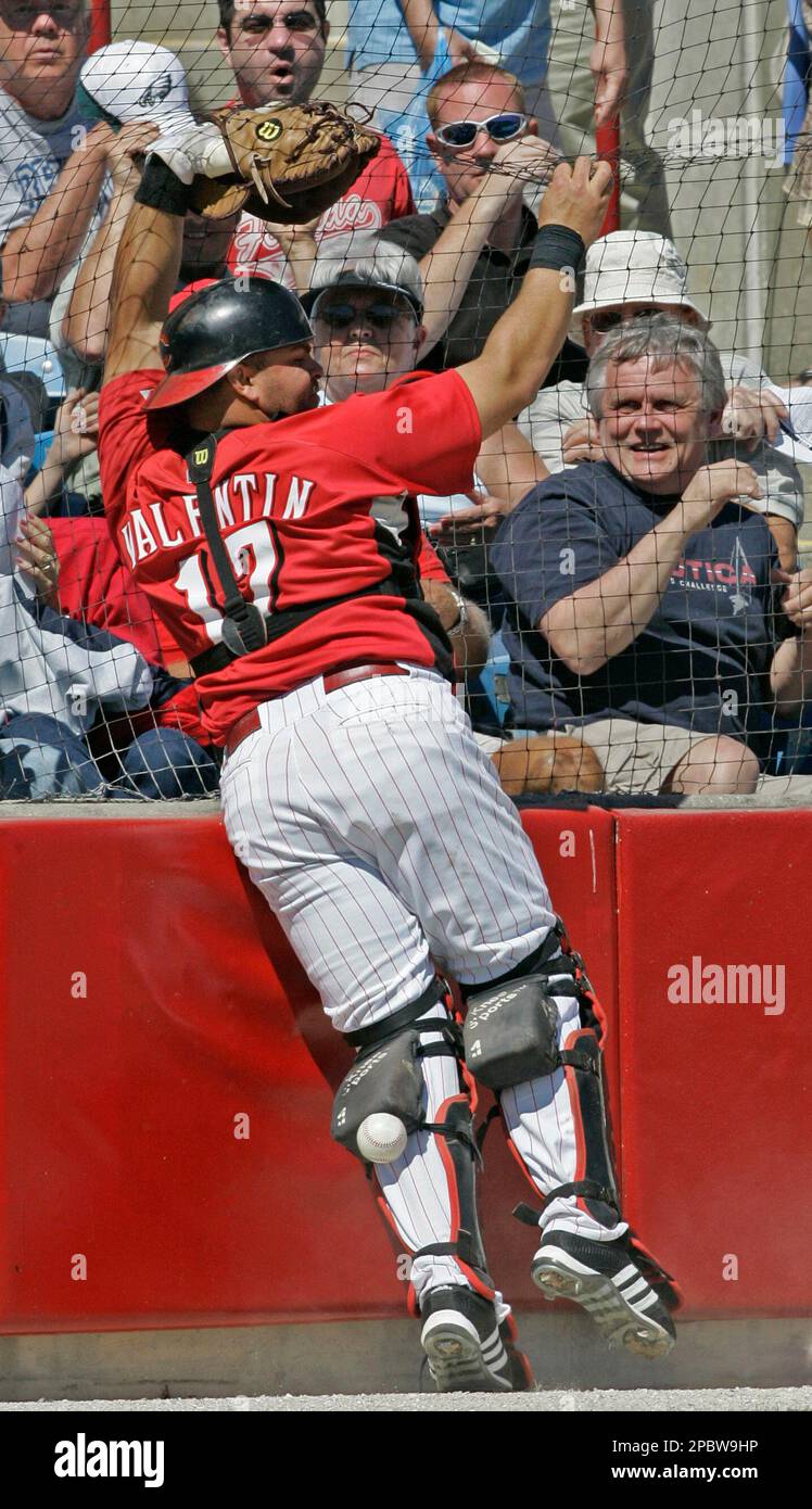 Cincinnati Reds catcher Javier Valentin misses a foul ball against the
