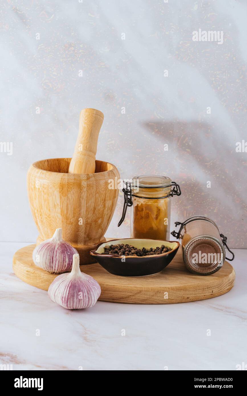 wooden mortar and black pepper Stock Photo