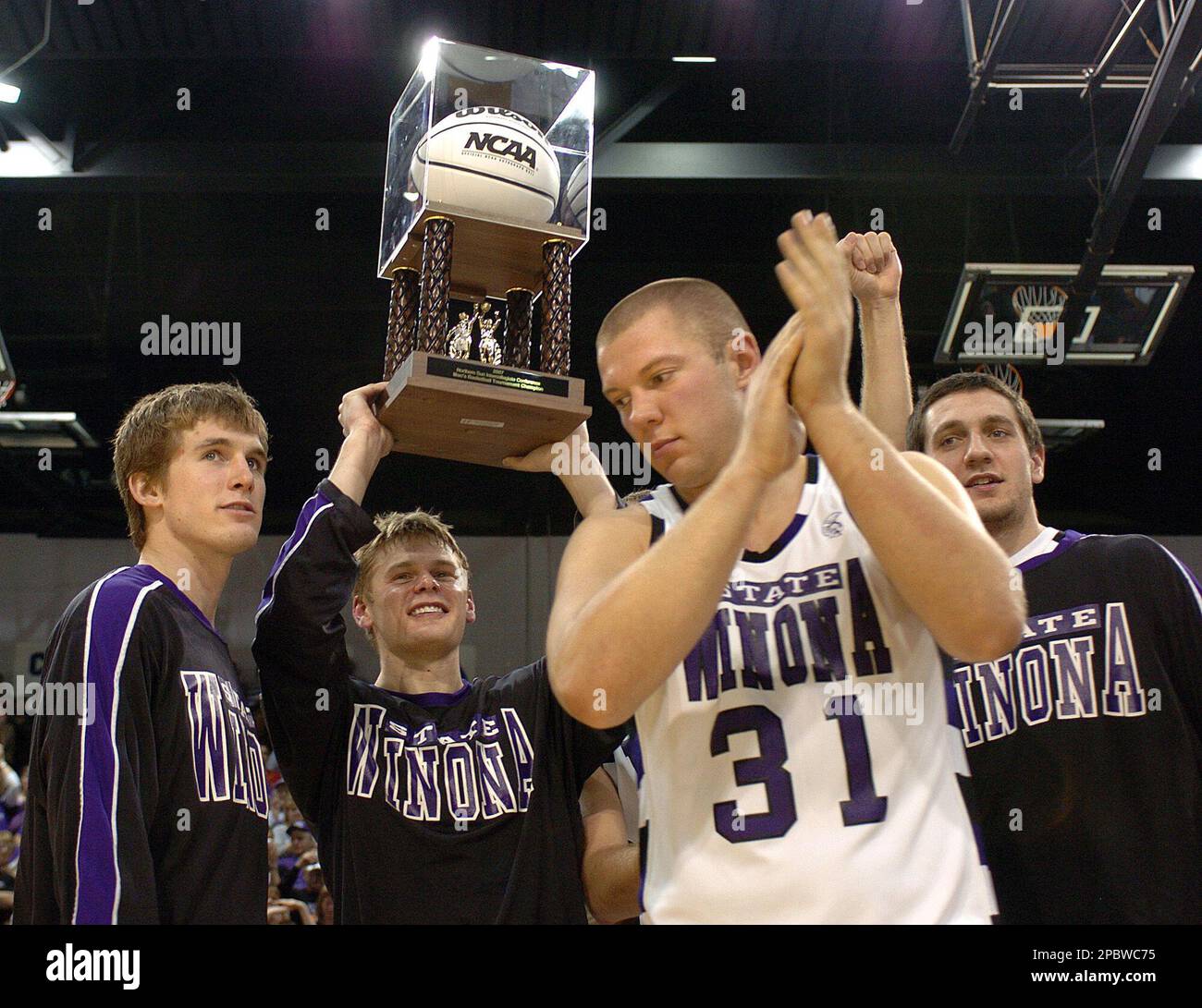 Winona State players from left, David Johnson, Zach Malvik, Brandon Stromer  and Ryan Gargaro, celebrate their NSIC tournament championship following a  80-70 win over Southwest Minnesota State Sunday, March 4, 2007, at, image size:1300x1091