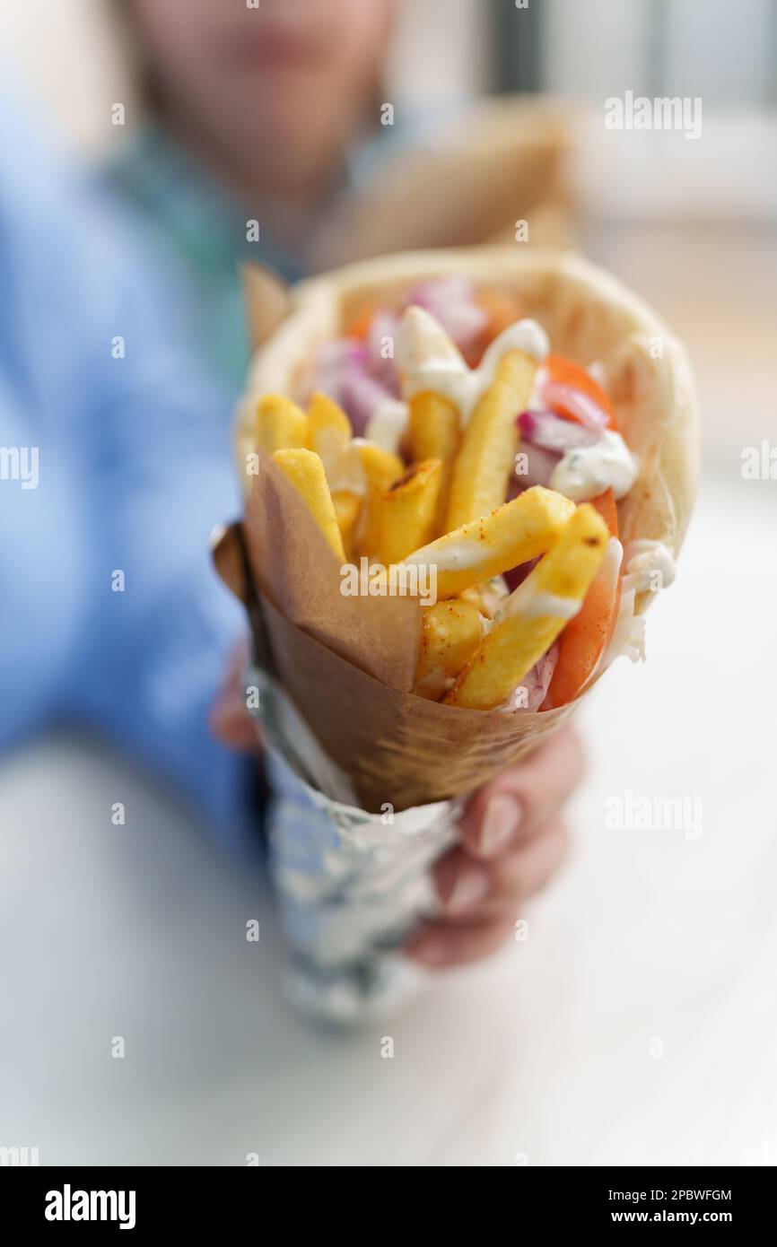 Traditional Greek gyros with pita bread, French fries, tzatziki sauce