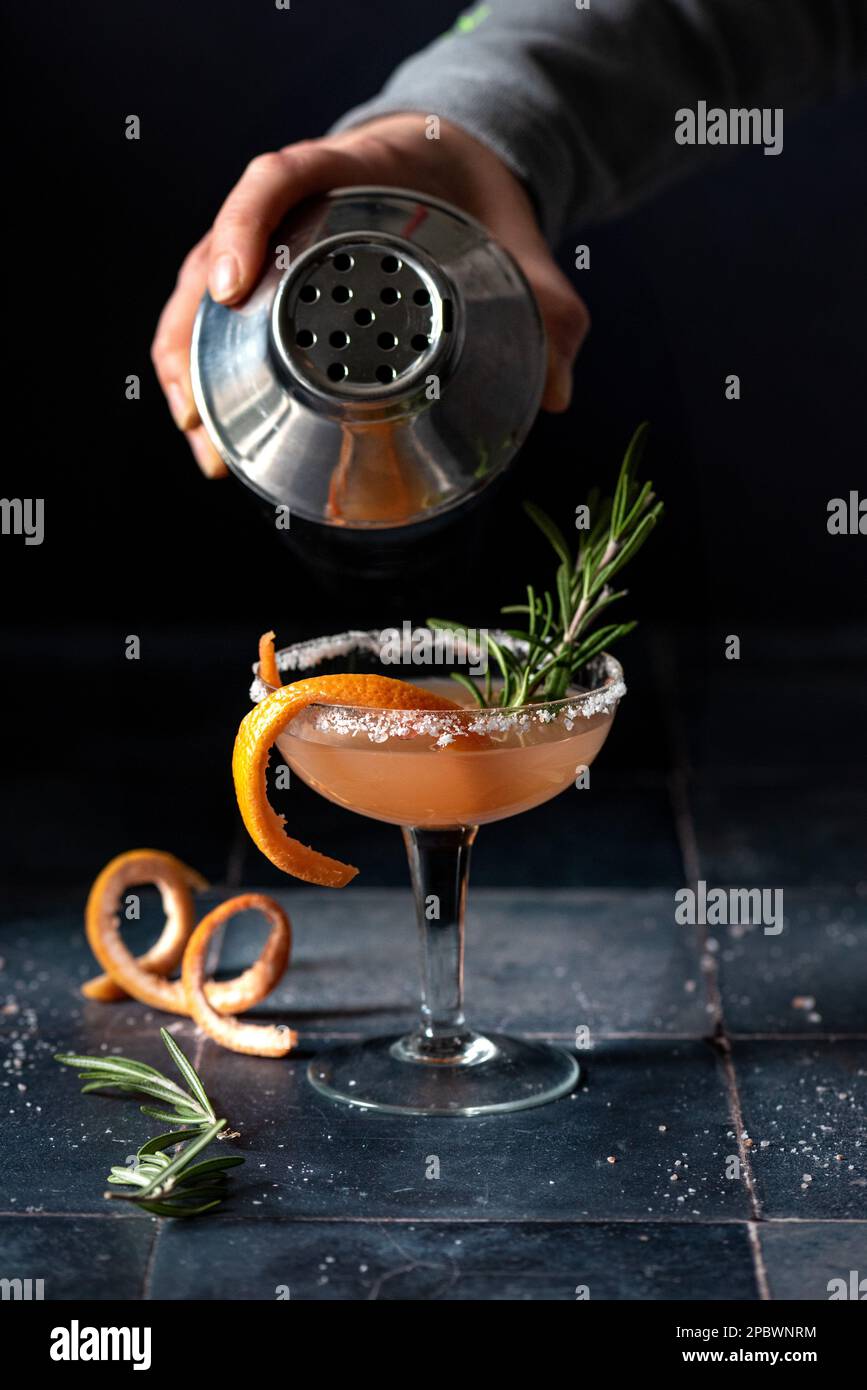 About to pour gin cocktail from shaker Stock Photo Alamy