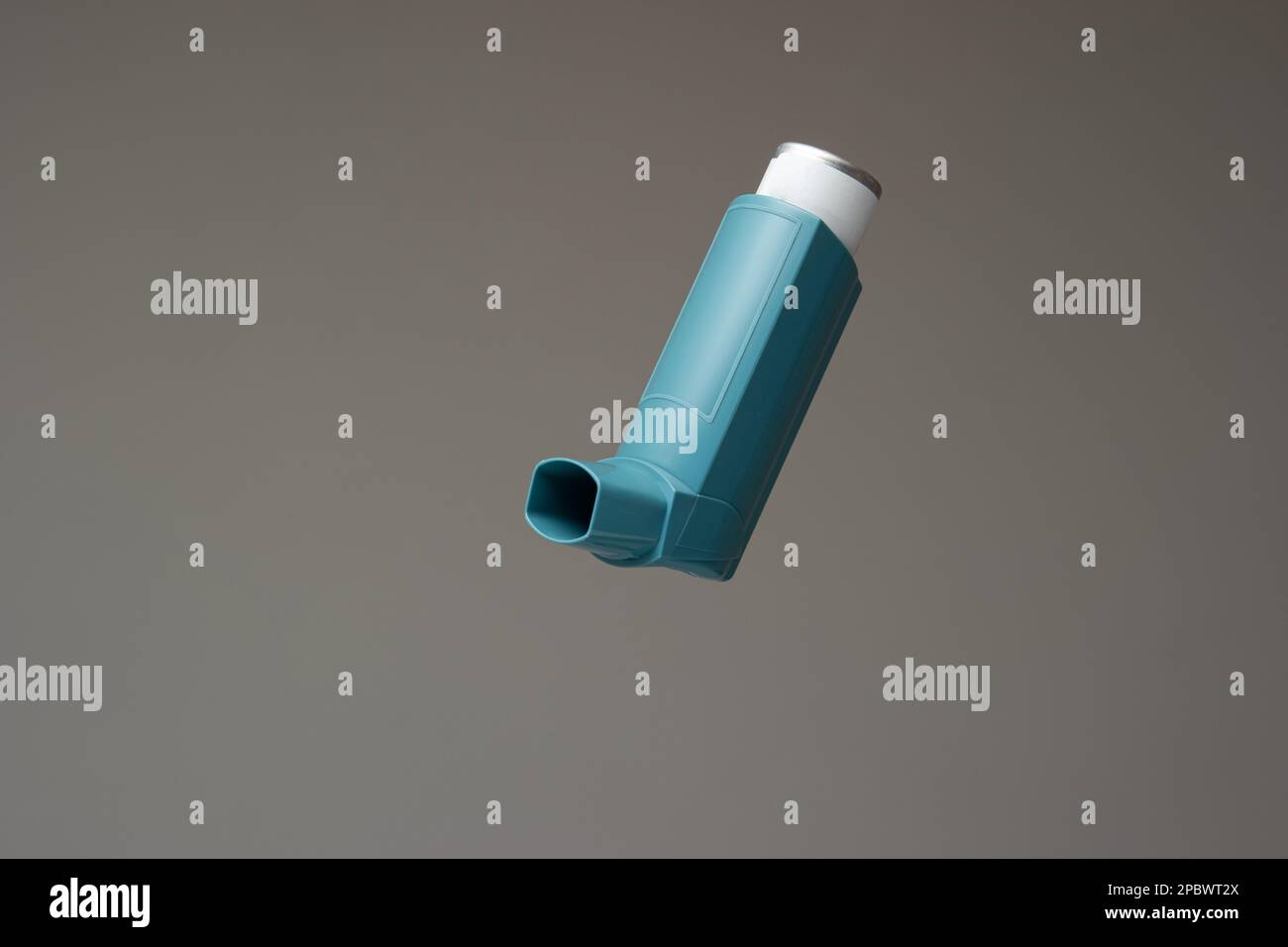 Asthma inhaler, generic, non-branded. Close up studio shot, isolated on gray background. Stock Photo