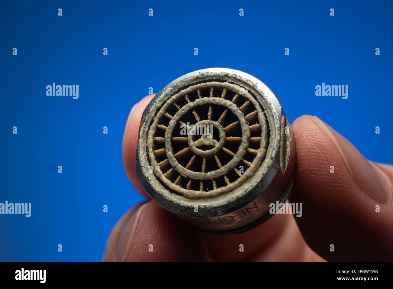 Old dirty limescale covered clogged up tap water faucet strainer or