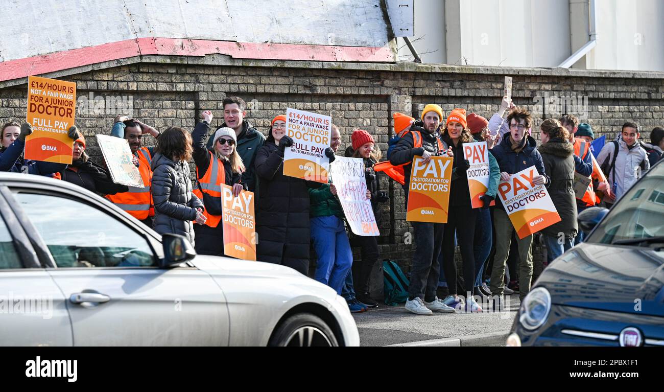 Brighton UK 13th March 2023 - Junior Doctors on strike outside the Royal Sussex County Hospital in Brighton this morning as they take part in the walk out in England . Thousands of junior doctors are launching a three-day strike in a dispute between the BMA and government over pay and conditions : Credit Simon Dack / Alamy Live News Stock Photo