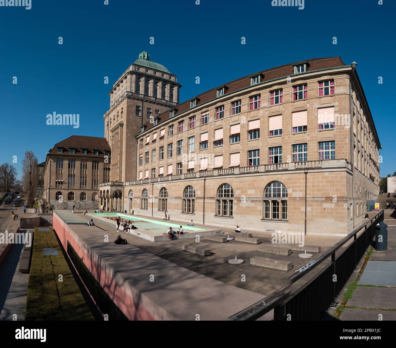 ETH University Zurich, Switzerland. Daytime, blue sky, wide angle view. Students enjoying their break sitting outside. Stock Photo