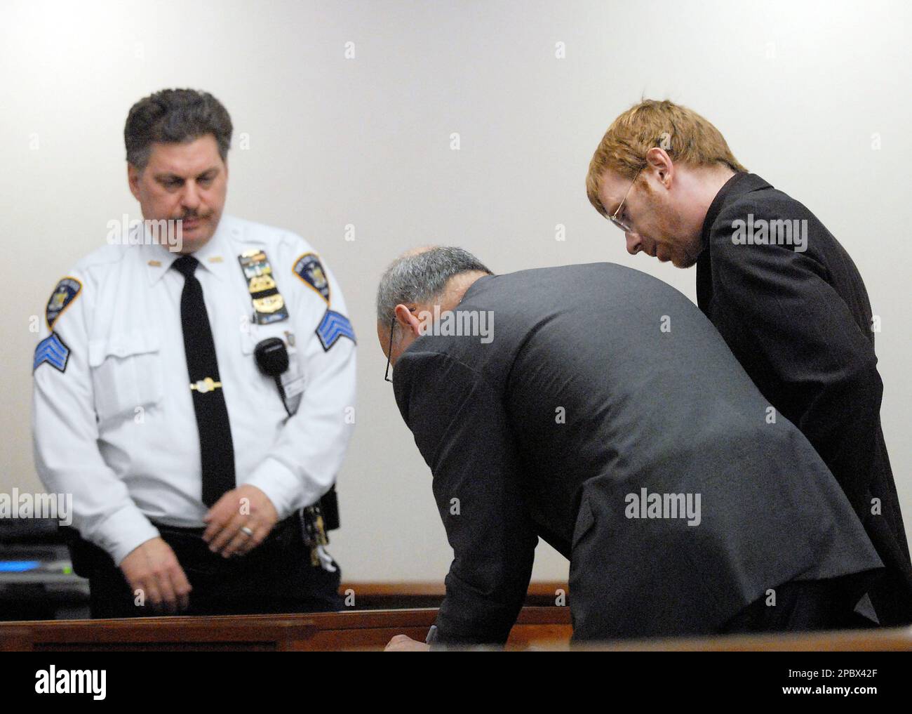 Former Phish singer Trey Anastasio , right, signs papers with his lawyer Steve Coffey, center, during Anastasio's appearance in Washington County court in Fort Edward, N.Y, Tuesday afternoon, Feb. 27, 2007, Arrested on drug charges during a Dec. 15 traffic stop, former Phish singer Trey Anastasio pleaded not guilty Tuesday and was released on bail. (AP Photo/The Post Star, Erin Reid Coker) Stock Photo