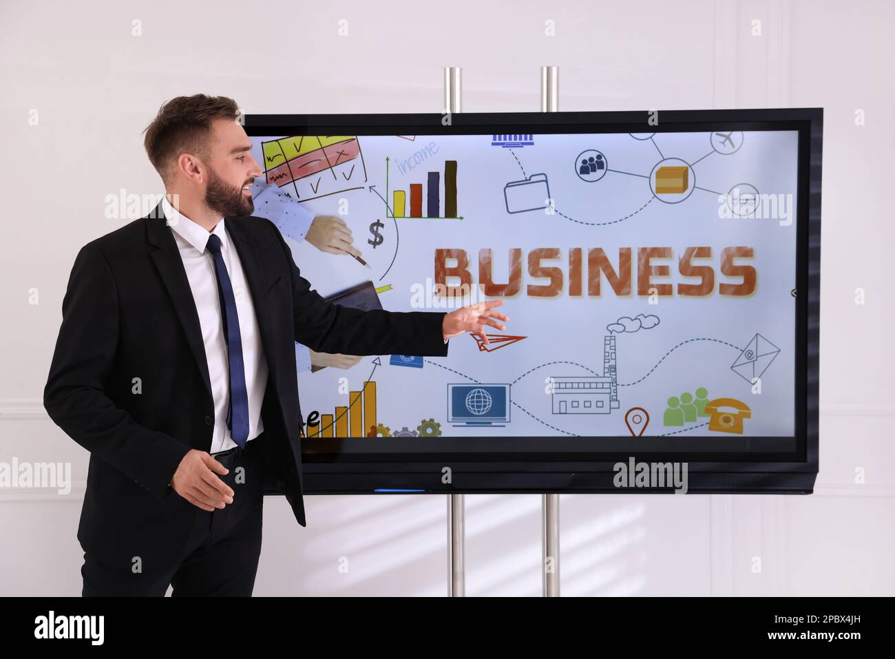 Business trainer using interactive board in meeting room Stock Photo
