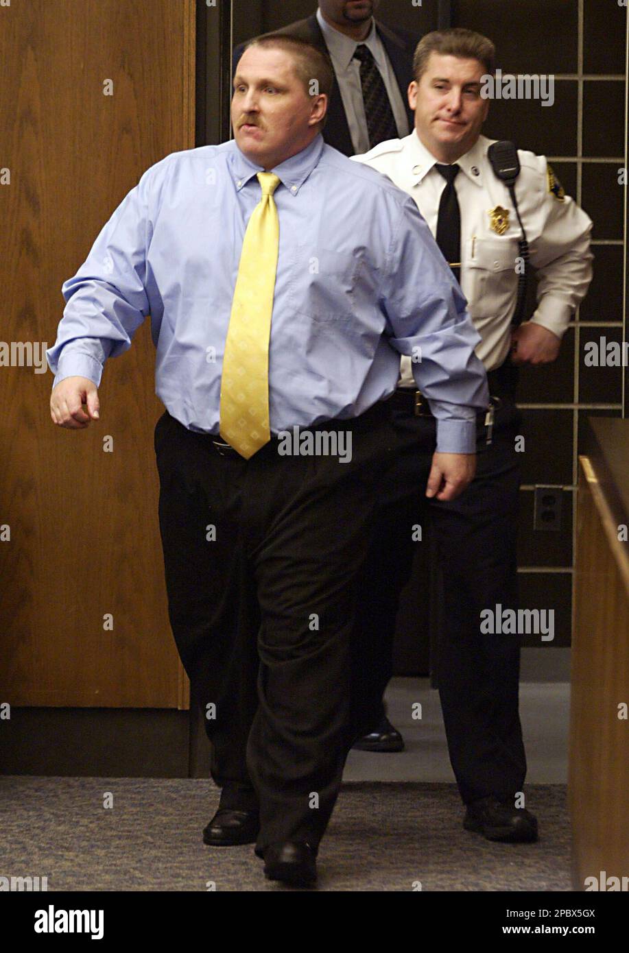 Michael Bizanowicz left enters the courtroom during a preliminary Michael Bizanowicz left enters the courtroom during a preliminary