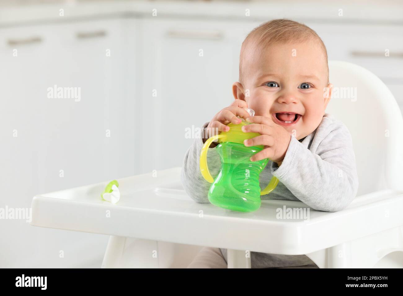 https://c8.alamy.com/comp/2PBX5YH/cute-little-baby-with-sippy-cup-at-home-space-for-text-2PBX5YH.jpg