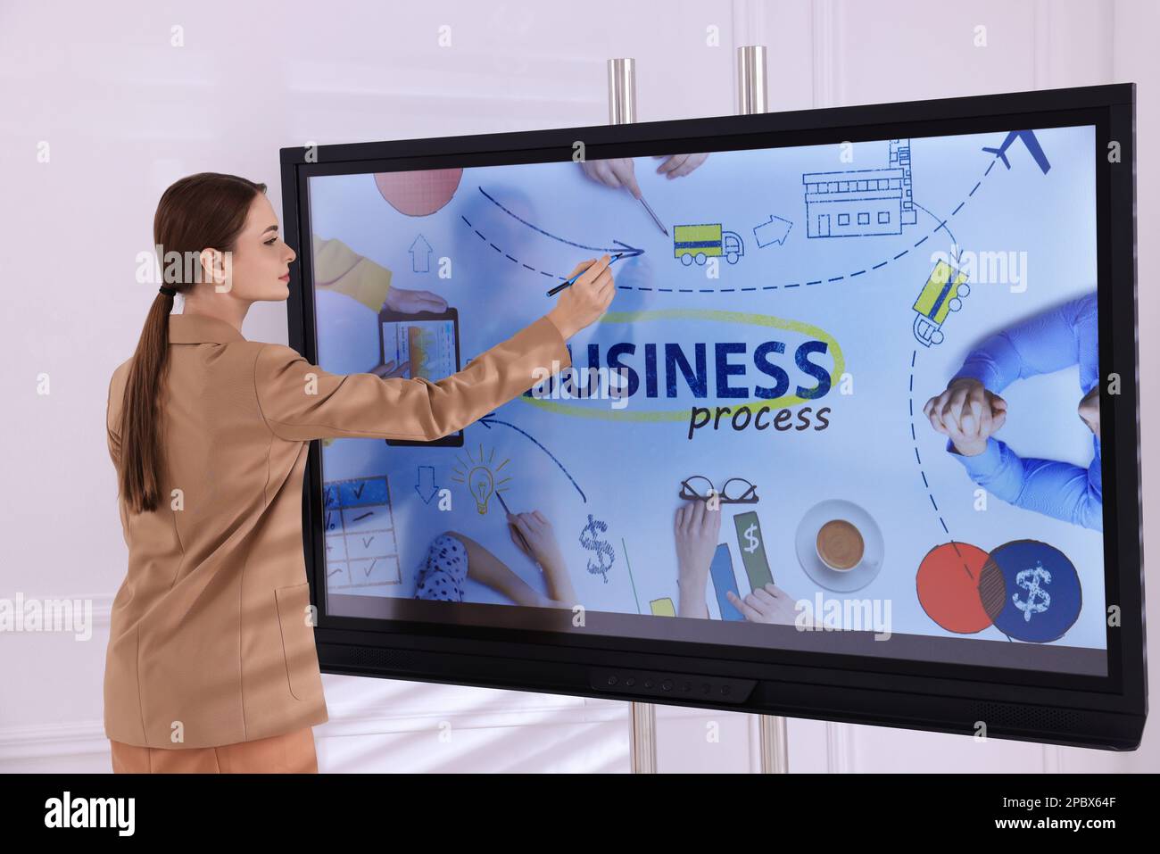 Business trainer using interactive board in meeting room Stock Photo