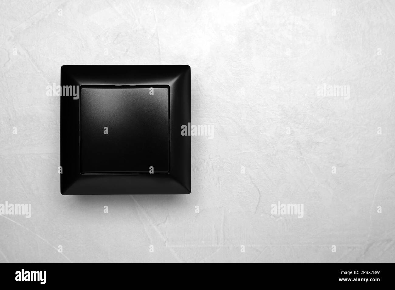 Black light switch on grey background, top view. Space for text Stock Photo
