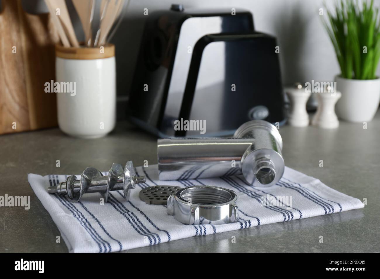 Clean parts of electric meat grinder on grey table indoors Stock Photo