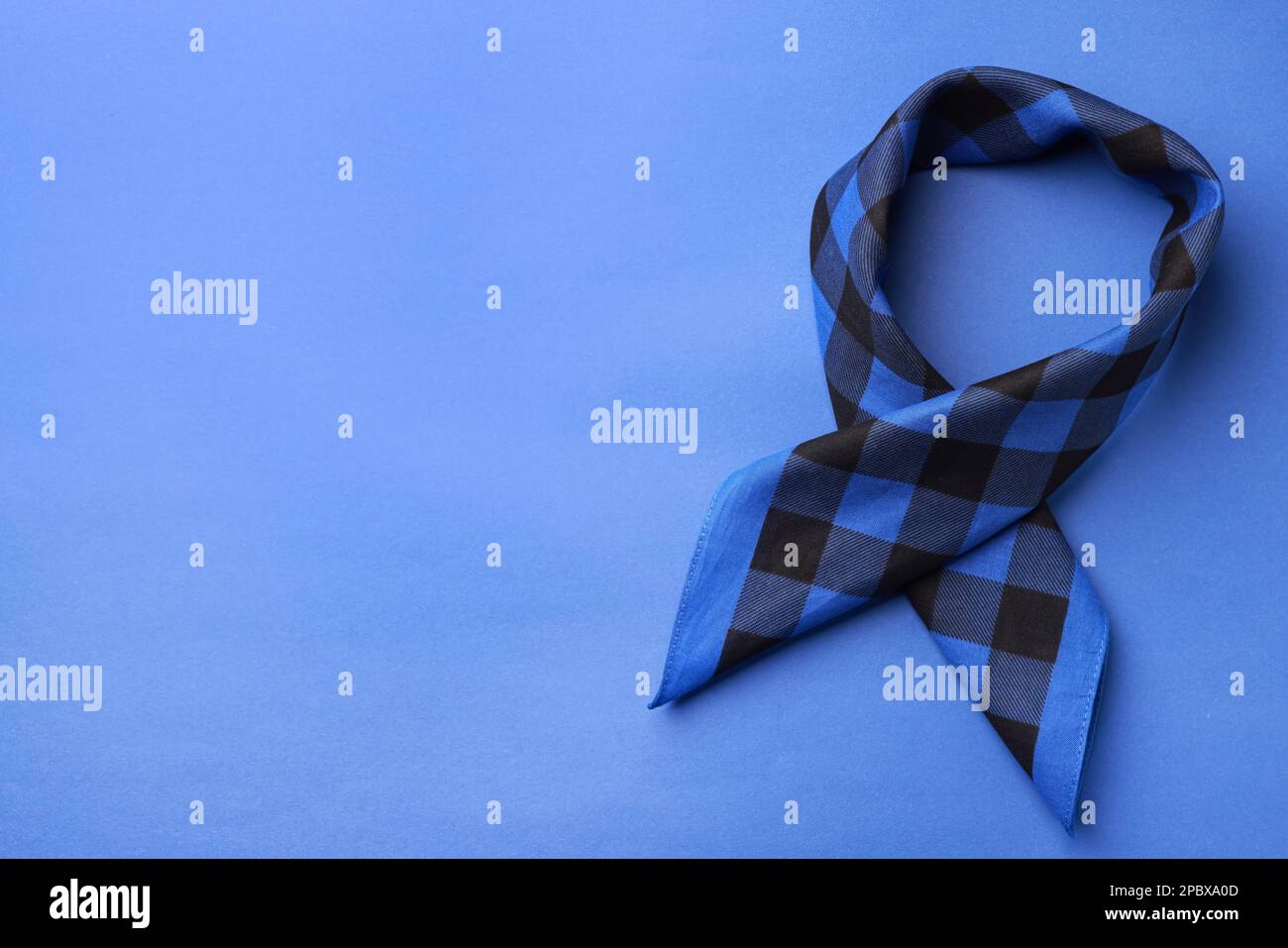 Folded bandana with check pattern on blue background, top view. Space for text Stock Photo