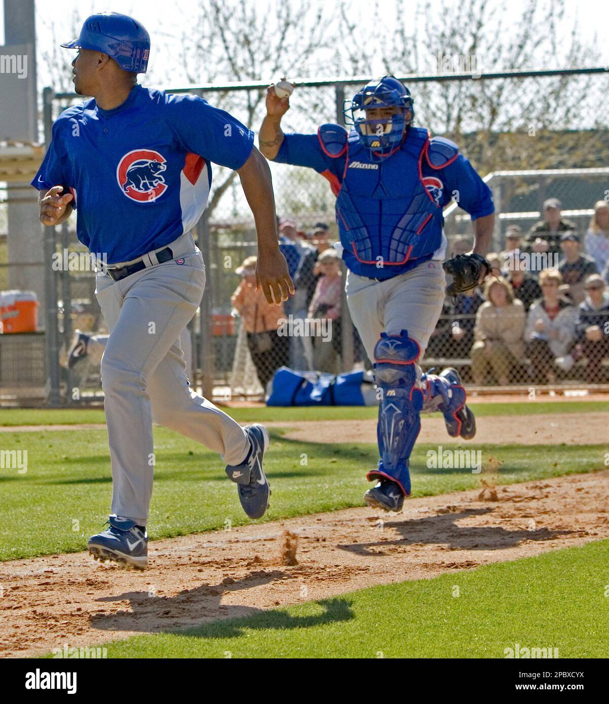 Chicago Cubs catcher Henry Blanco tries to run down Jacque Jones during 