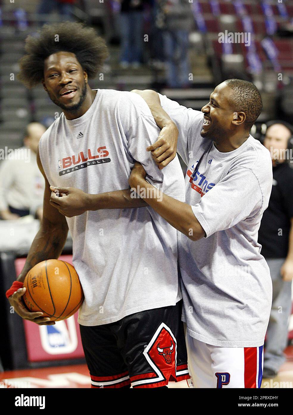 Detroit Piston's Lindsey Hunter, right, clowns around with former