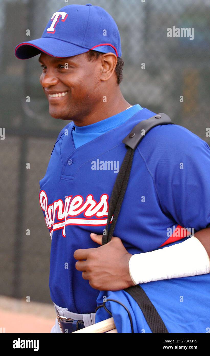 Texas Rangers' Sammy Sosa smiles as he walks to the field to report for his  first day of spring training workouts with the team in Surprise, Ariz.,  Friday, Feb. 23, 2007. (AP