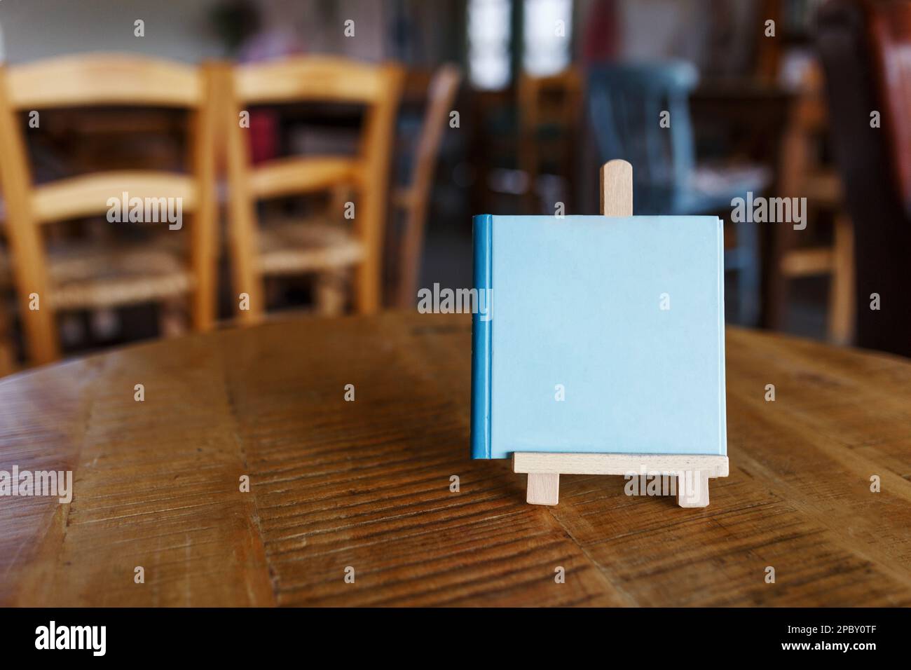 Mock up menu object in cafe and restaurant,blank screen for booklet with white sheets of paper on wooden table on cafeteria,promotion and information Stock Photo