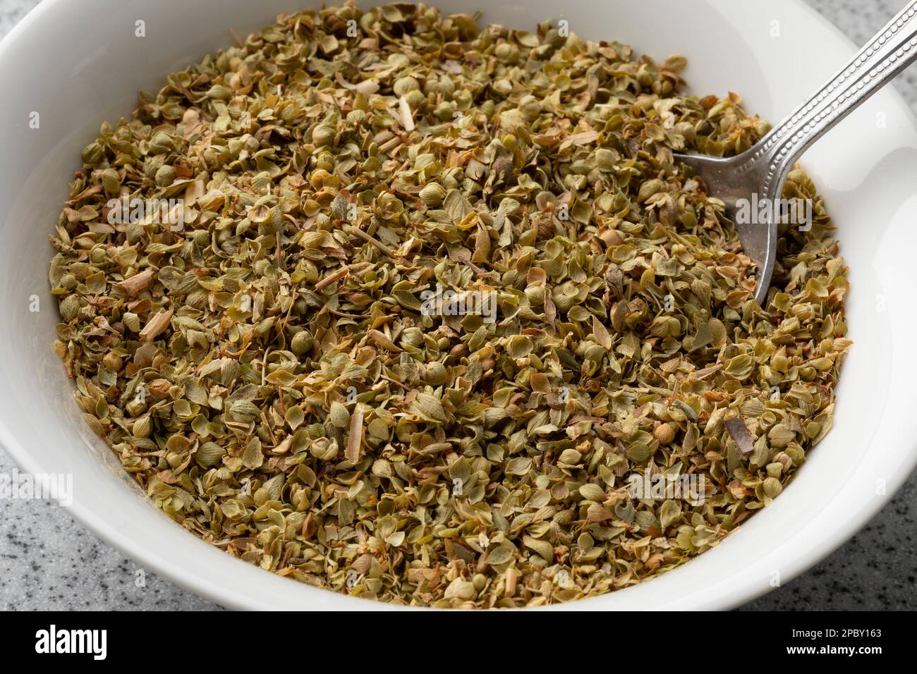 White bowl with dried za'atar close up for seasoning Stock Photo