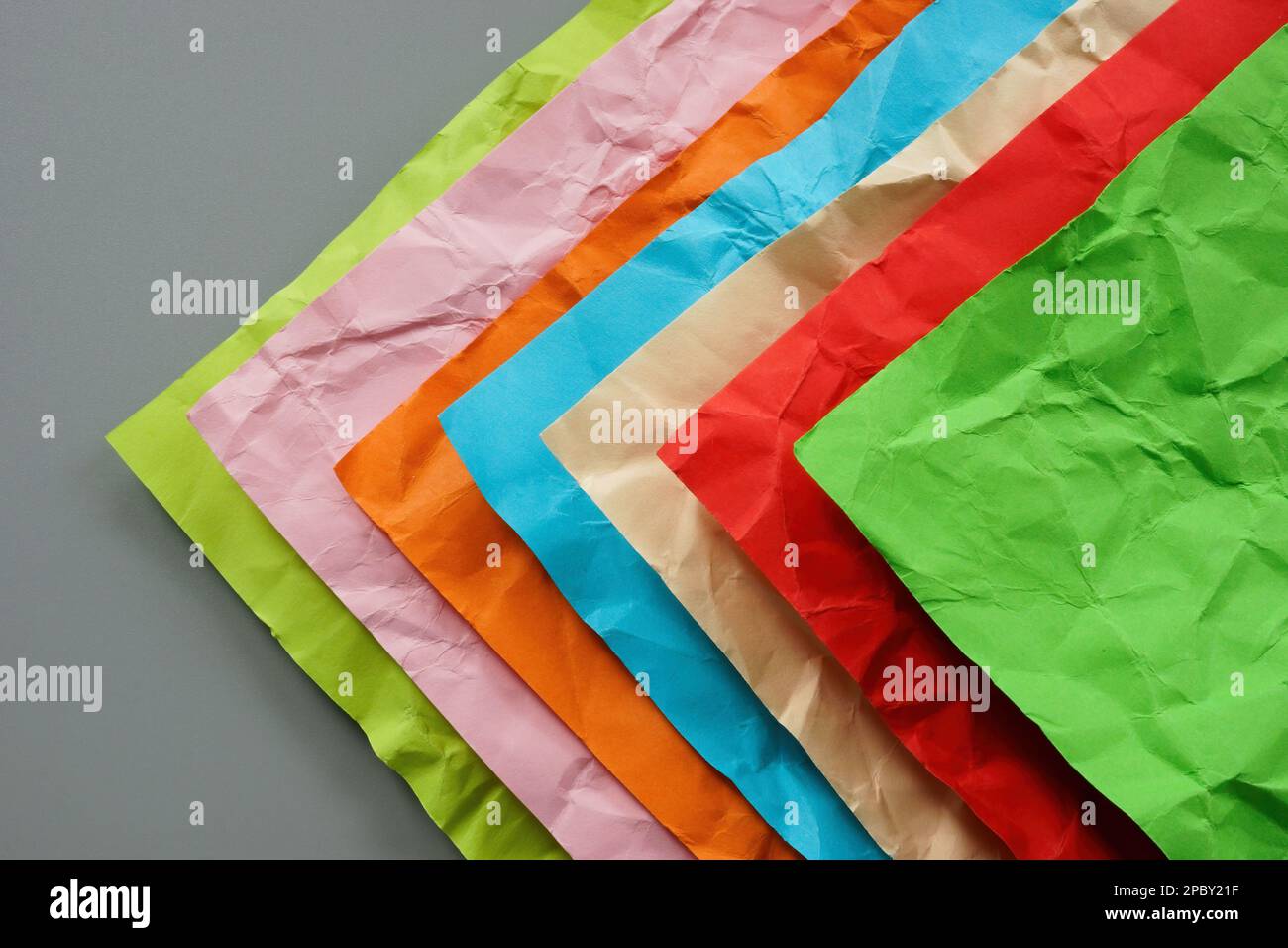 Multi-colored crumpled sheets of paper as a concept of diversity. Stock Photo