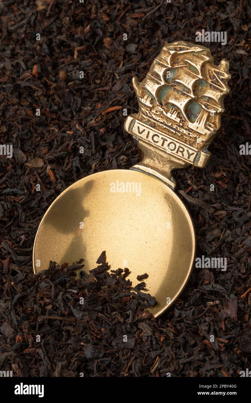 Vintage brass English Tea caddy spoon in dried Java Melange tea leaves