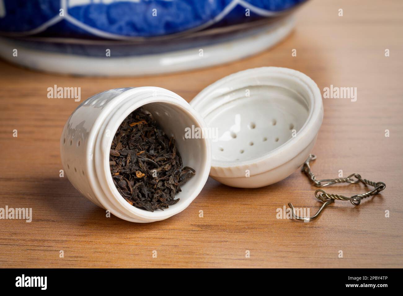 White Tea Pot And Cup With Tea Strainer On Wooden Table, Relaxing With Hot  Tea During Tea Break. Stock Photo, Picture and Royalty Free Image. Image  84607717.