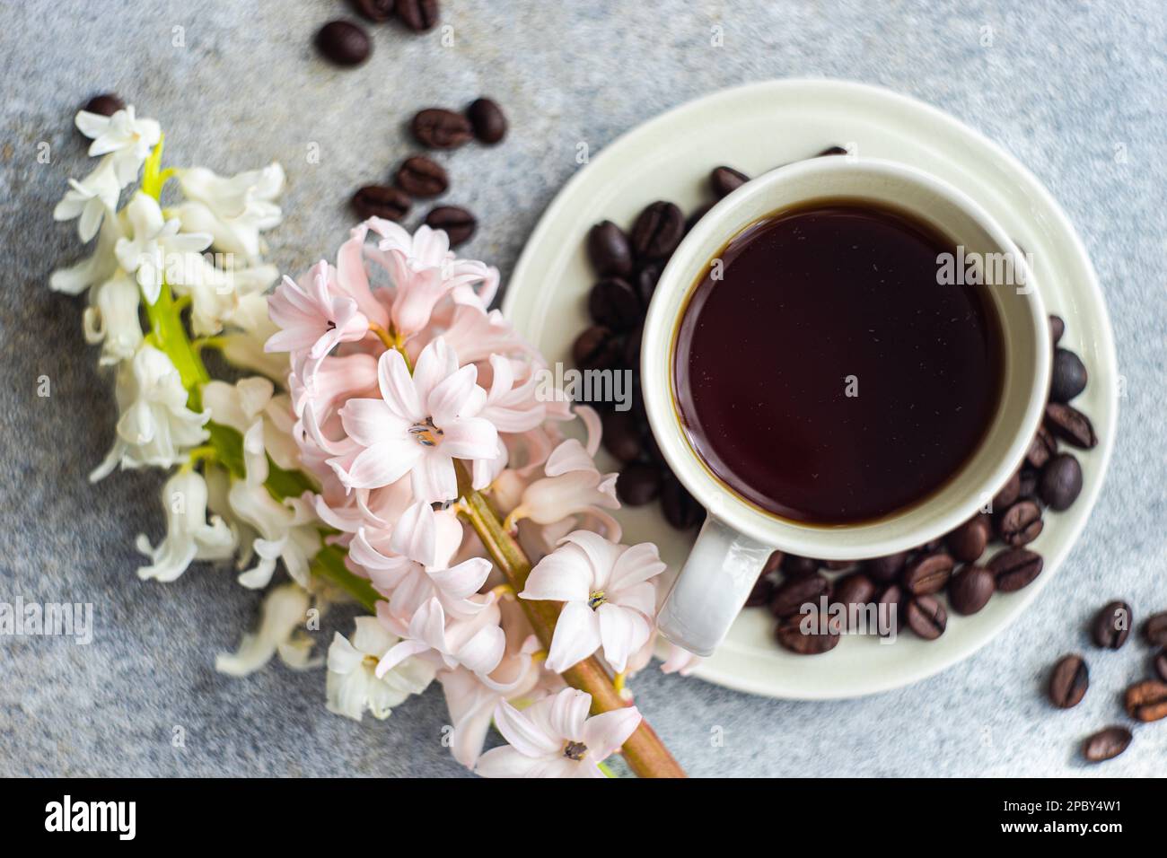 Cup of black coffee served on concrete table in the sunny morning Stock Photo