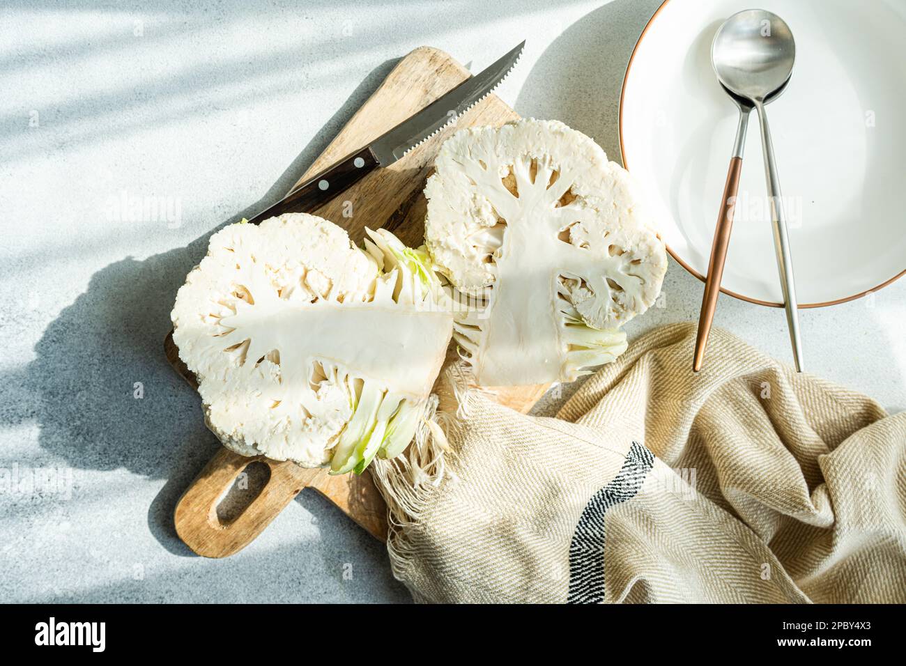 Raw cauliflower vegetable ready for cooking on concrete table Stock Photo