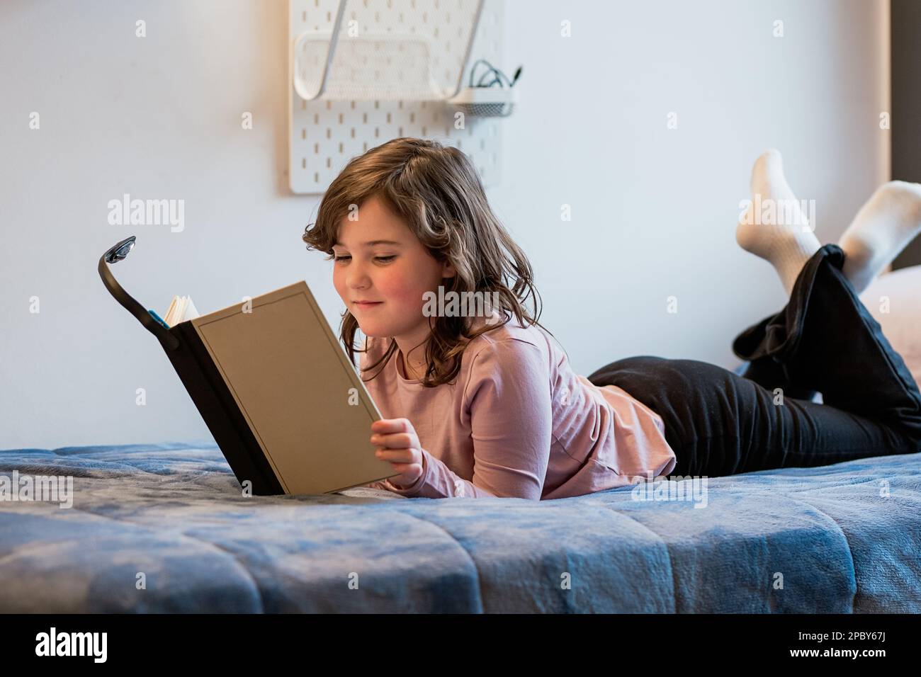 Preteen girl lying on bed hi-res stock photography and images - Alamy