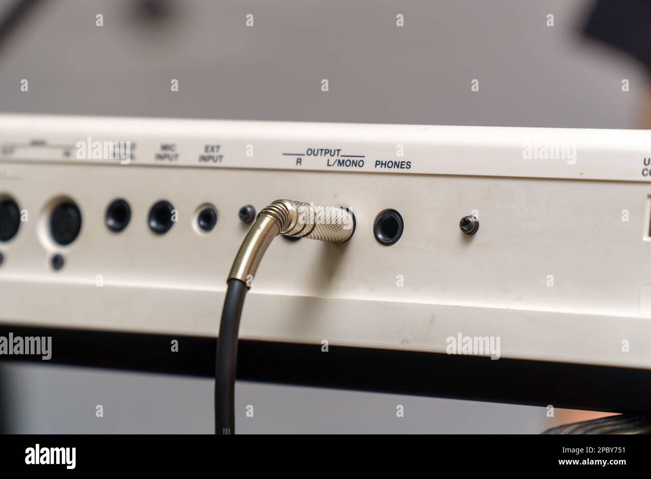 Audio jacks are plugged into a guitar synthesizer or processor Stock