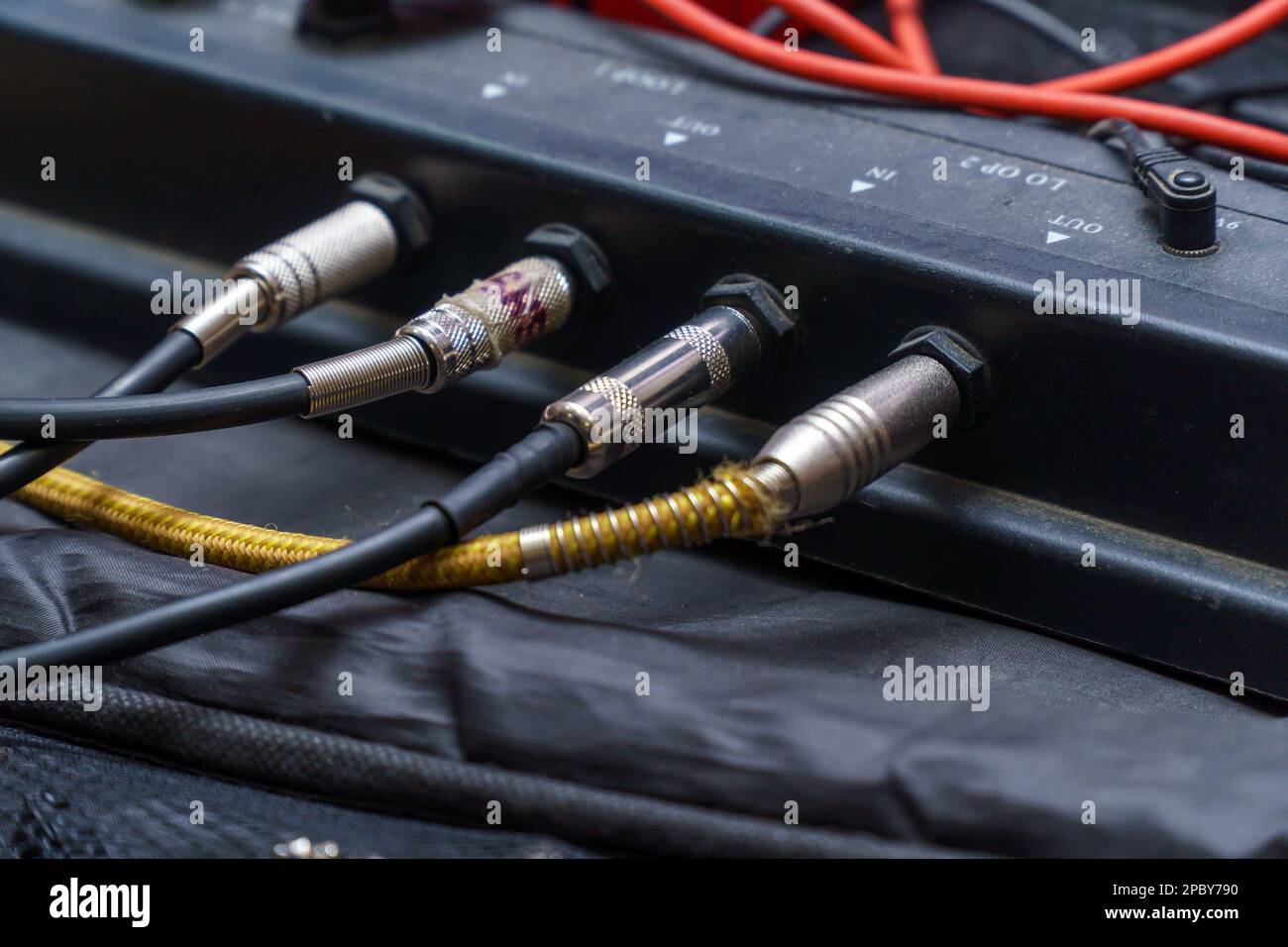 Audio jacks are plugged into a guitar synthesizer or processor Stock