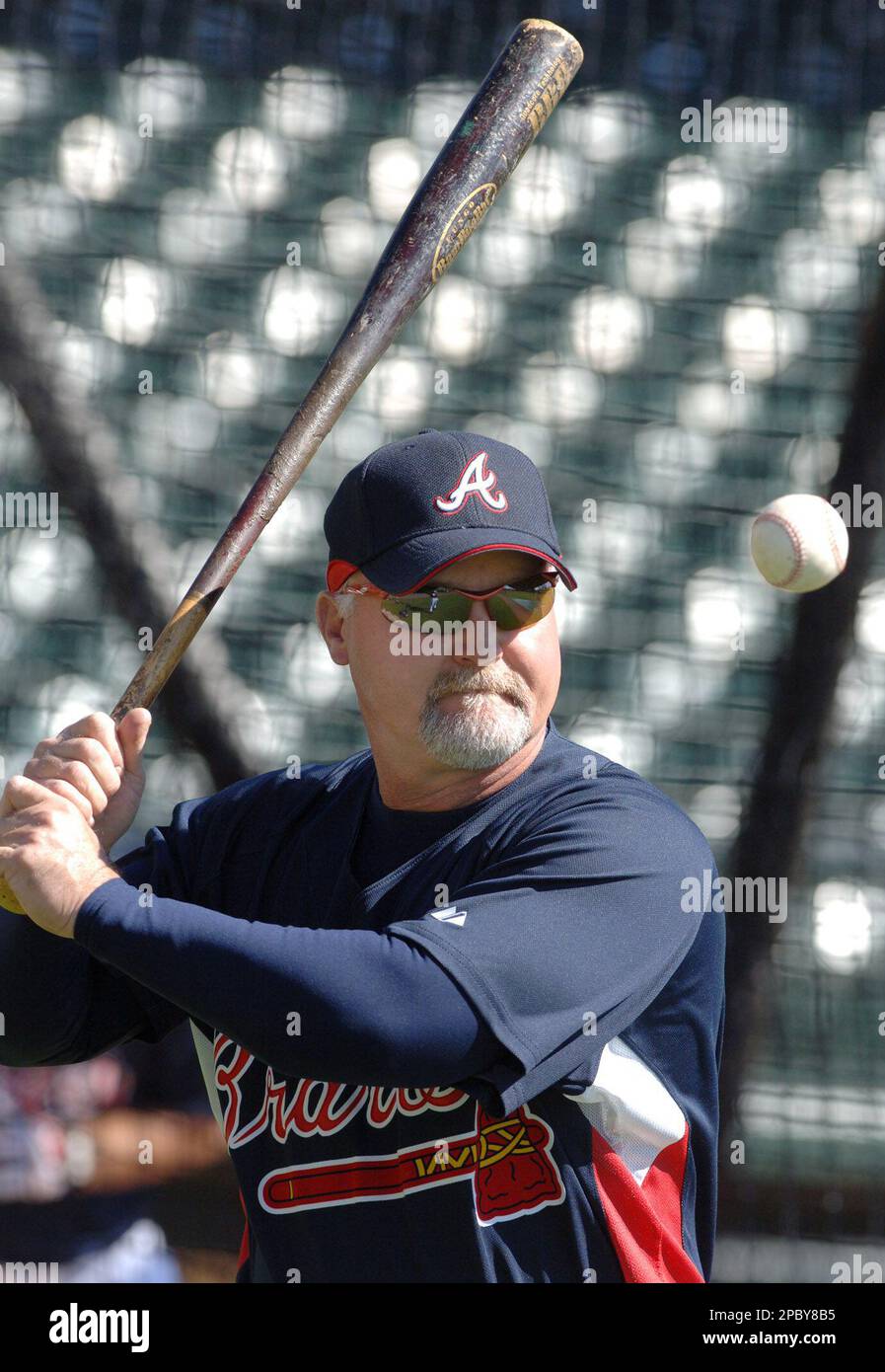 Atlanta Braves coach Glenn Hubbard hits grounders in the infield