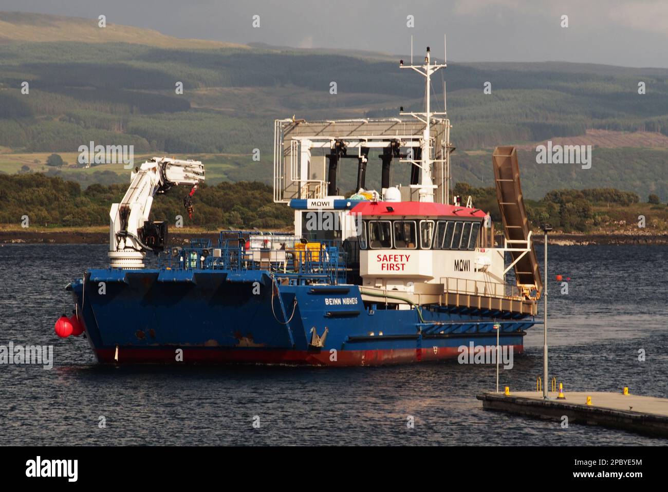 A Mowi salmon fishing vessel at Tobermory, Mull, Scotland just starting out on a shift Stock Photo