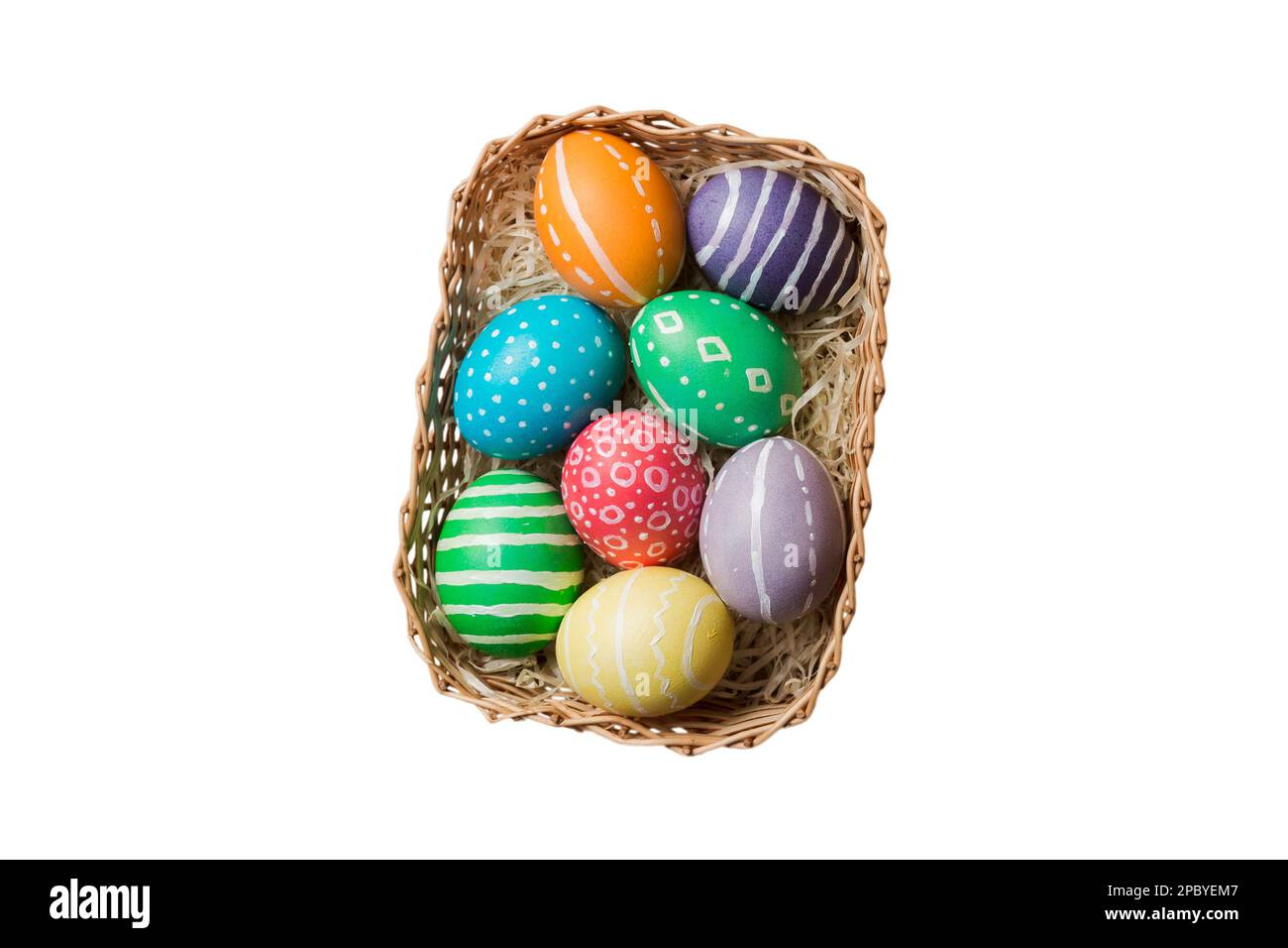 Basket of colorful Easter eggs isolated on white background. Easter basket filled with colored eggs top view holiday concept . Stock Photo