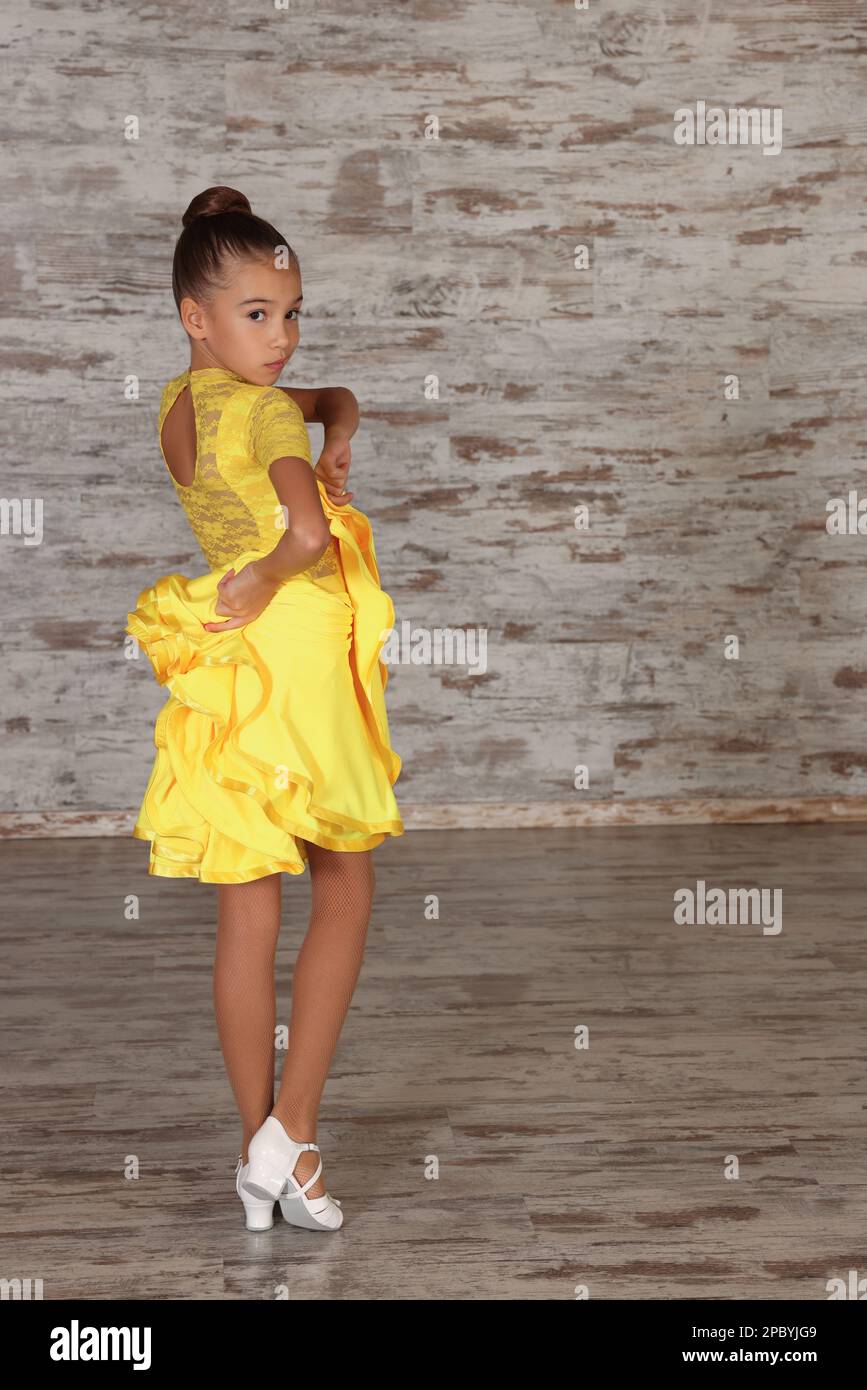 Beautifully dressed little girl dancing in studio Stock Photo Alamy