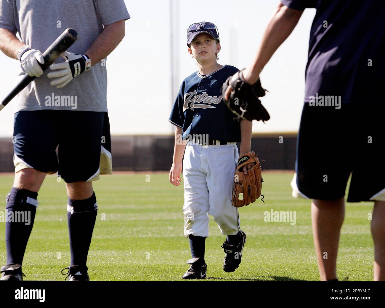 Quinn Hoffman, 9, son of San Diego Padres pitcher Trevor Hoffman, leaves  the field between major league players after catching balls in the outfield  at baseball spring training, Friday, Feb. 16, 2007