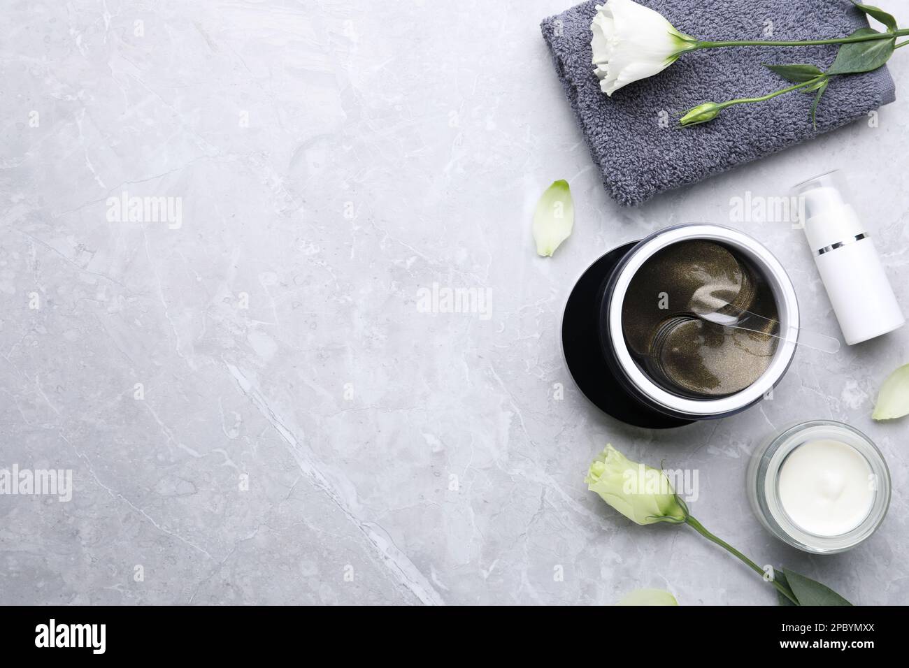 Flat lay composition with under eye patches on light grey marble table ...