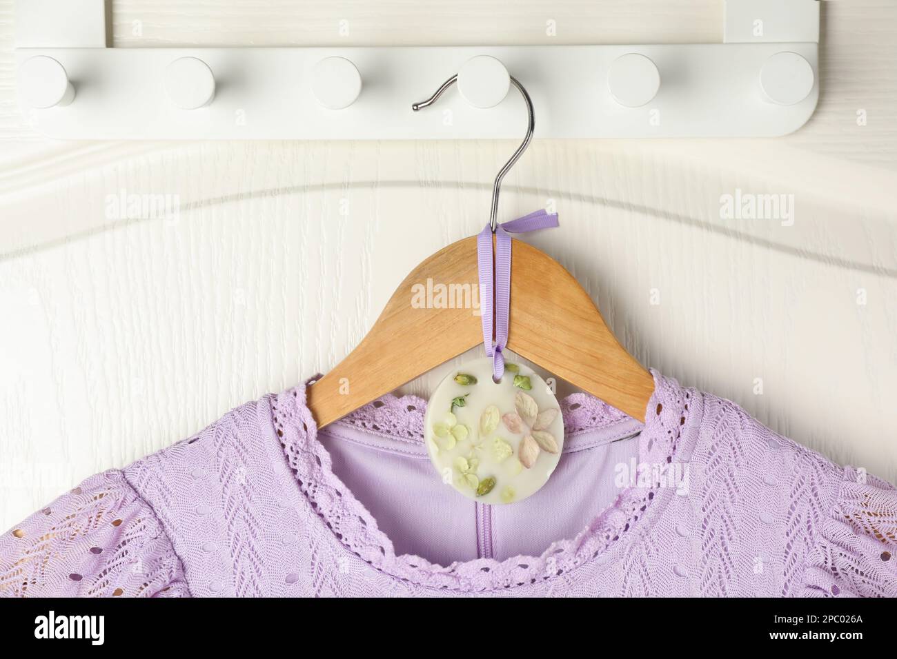 Scented sachet with flowers and stylish clothes on hanger Stock Photo -  Alamy