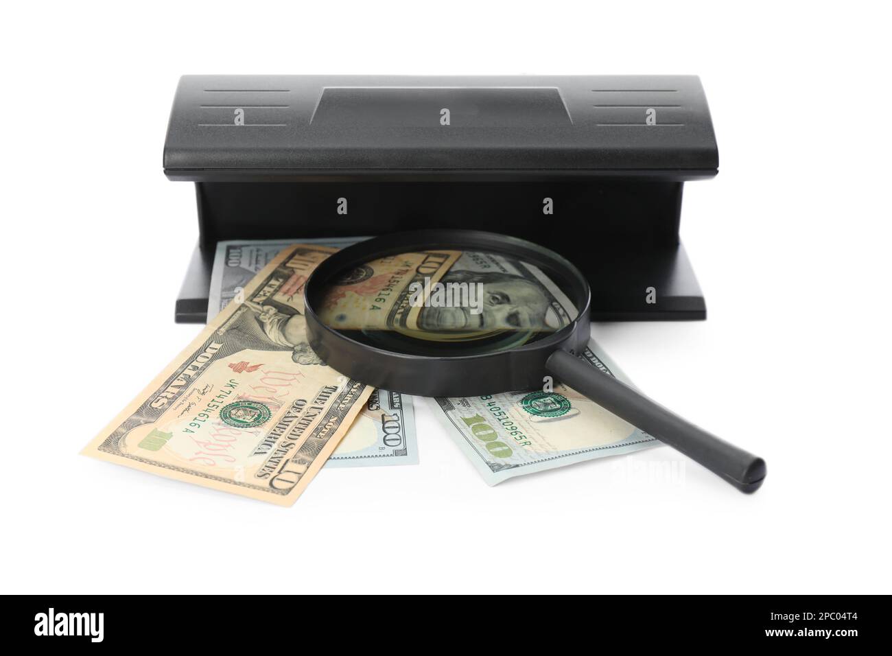 Modern currency detector with dollar banknotes and magnifying glass on