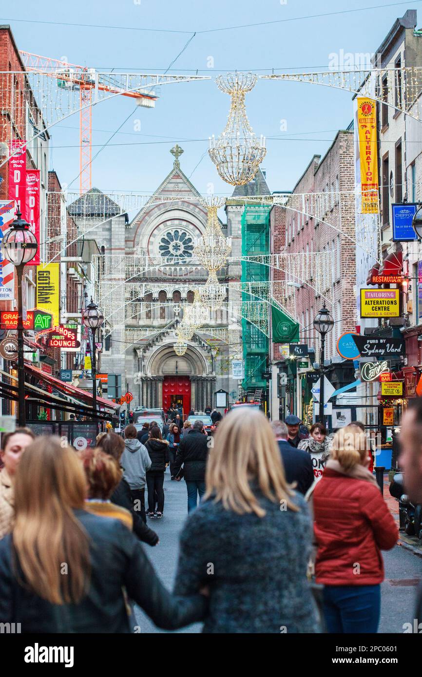 Christmas shoppers throng Dublin, Ireland's outdoor shopping mall on Grafton Street Stock Photo