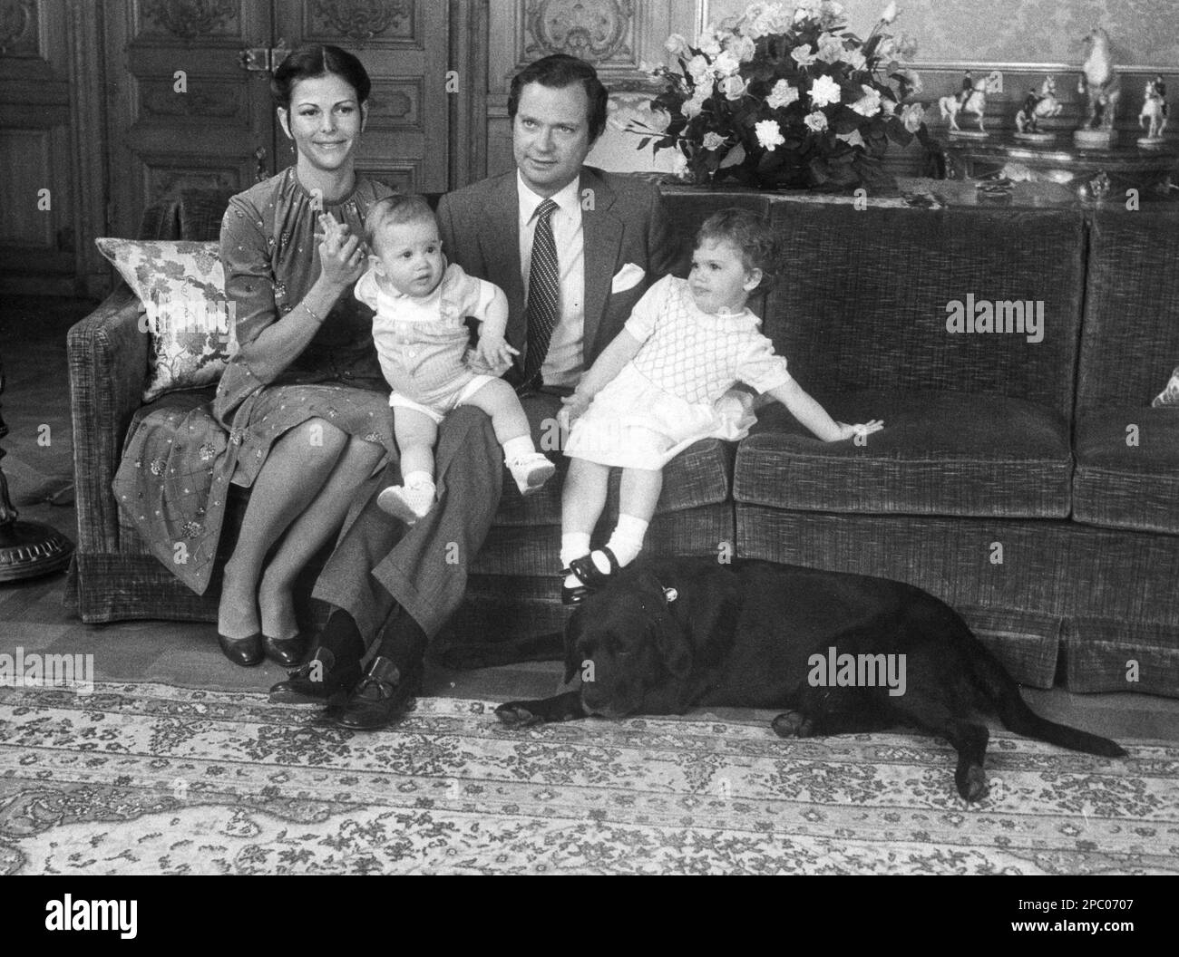 Swedish KING CARL XVI GUSTAF with wife Queen Silvia and the children Carl Philip and Princess Victoria in a sofa at Royal Palace in Stockholm Stock Photo